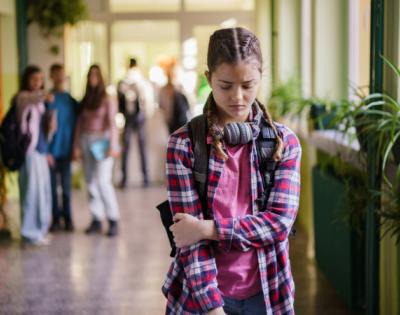 Girl crossing arms in the hallway getting bullied